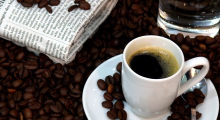 black coffee, coffee beans and newspaper